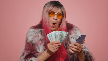 Happy tourist woman looking smartphone display sincerely rejoicing win, receiving money dollar cash...