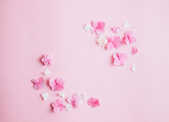 Obraz na płótnie Canvas Valentine's Day background. Frame made of pink flowers, hearts on pastel pink background. Valentines day concept.