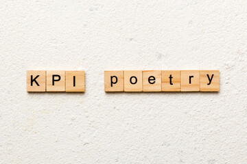 KPI poetry word written on wood block. KPI poetry text on table, concept
