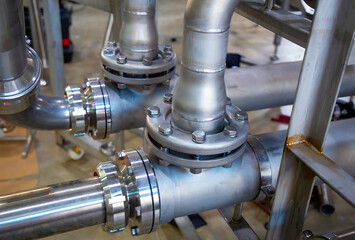 Stainless steel pipes and flanges used in food industry.