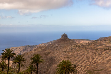 Panoramic view on Rocky Mountain peaks and the hilly landscape on the way to Valle Gran Rey, La Gomera, Canary Islands, Spain, Europe. Remote coastline of the Atlantic Ocean. Peaceful, silent location