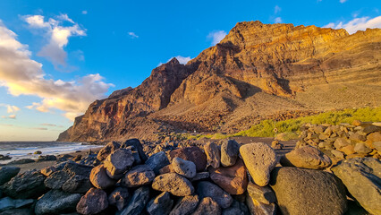 Scenic view during sunset on the volcanic sand beach Playa del Ingles in Valle Gran Rey, La Gomera,...