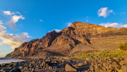 Scenic view during sunset on the volcanic sand beach Playa del Ingles in Valle Gran Rey, La Gomera,...