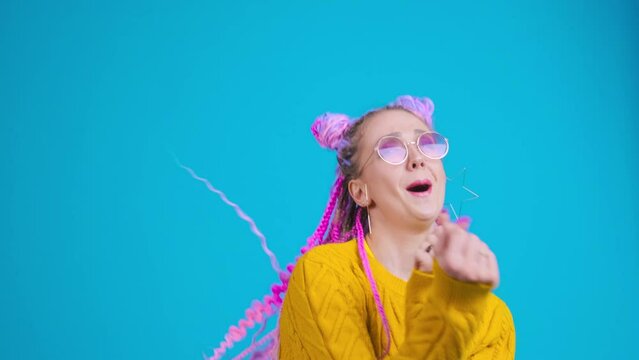 Happy woman dancing, excited and emotional person. Young student, creative freelancer with colorful hair and afro braids dreadlocks moving, positive emotion, ecstatic feeling. Smiling happily