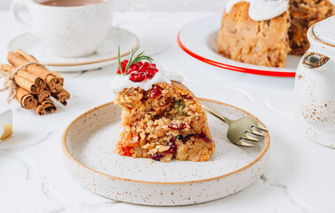 Traditional Christmas fruit pudding on white festive background.