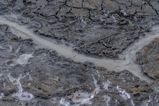 Thin stream of water on mud
