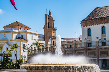 Selective focus on water flowing from fountain and drops, and Santo Domingo Convent in the...