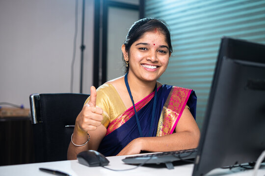 Happy Smiling Corporate Or Banking Employee Showing Thumbs Up By Looking Camera At Bank - Concept Of Successful, Confident And Banking Service.