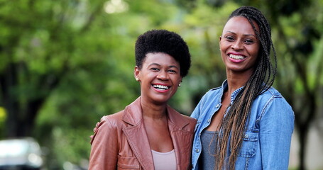 Obraz premium Two happy women smiling and laughing. African ethnicity girls smile and laugh together