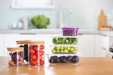 food glass containers with fresh fruits and vegetables at kitchen