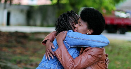 Two friends empathic hug. African women compassionate embrace