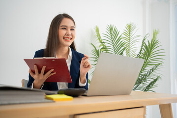 Happy young Asian women startup entrepreneur happy and excited smiling after getting email for success sign business contact, happy girl on the workplace. Distance learning online education and work.