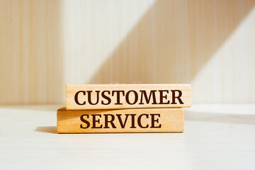 Wooden blocks with words 'customer service'.