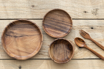 Top view of wooden bowl on wooden background