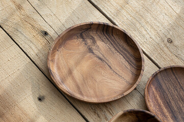 Top view of wooden bowl on wooden background