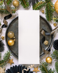 Black and golden Christmas Table setting with ornaments and fir tree branches. Menu card Mockup