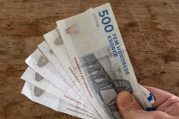 Copenhagen, Denmark A hand with 500 krone notes.