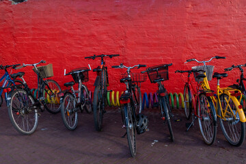 Copenhagen, Denmark Parked bicycles against a red wall.