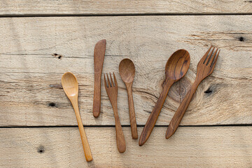 Wooden spoon and fork on wood texture of dining table
