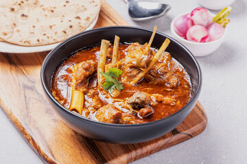 home cooked mutton gravy or mutton curry  with roti and onion salad