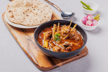 home cooked mutton gravy or mutton curry  with roti and onion salad