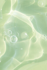 The texture of a green gel or serum with hyaluronic acid for the face. Cosmetic transparent liquid...
