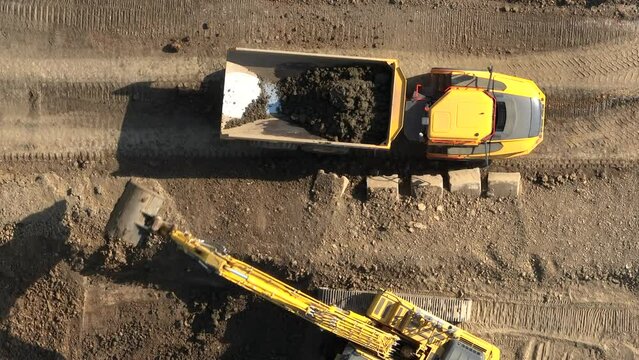 Tipper Truck Being Loaded Up With Earth by a Digger