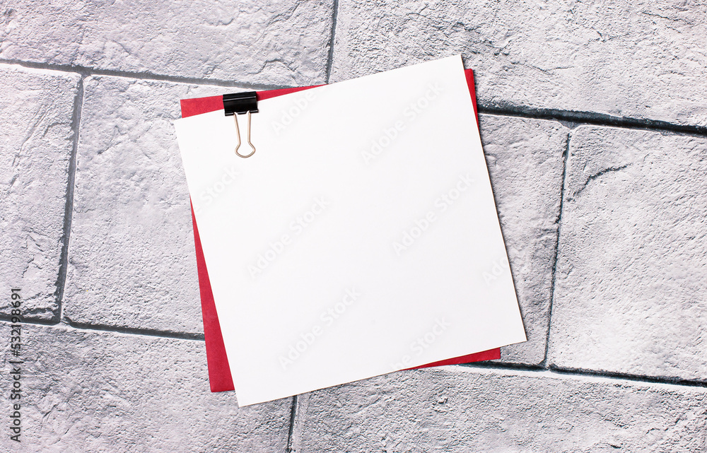 Poster a white sheet of paper with a place to insert text on a red envelope on a light marble background, c