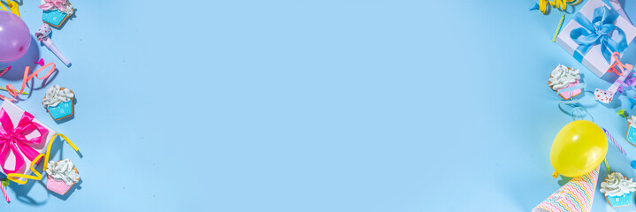 Happy birthday greeting card background. Flatlay with colorful holiday tools - birthday party caps, blowers, gift boxes , balloons, steamers, candles, on blue background copy space