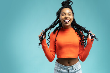 Young lovable woman with african hairstyle laughing during indoor photoshoot. Graceful cute girl