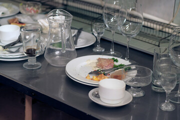 Dirty dishware on metal table