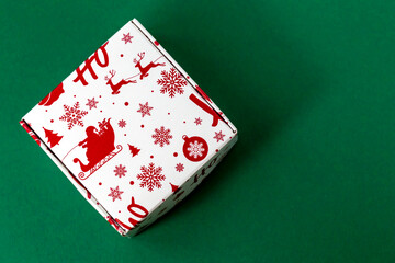 New Year gift box on a green background. Flat lay