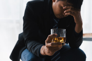 Alcoholism concept. Young man drinking alcohol too much. drunk asian man hold whisky glass addicted alcohol need therapy.