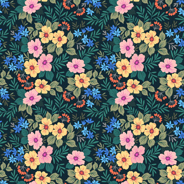 Beautiful floral pattern in small abstract flowers. Small colorful flowers. Dark blue background. Ditsy print. Floral seamless background. The elegant the template for fashion prints. Stock pattern.