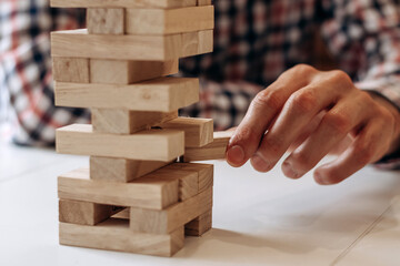 Hands of a man playing board game on a table at home,close up.Board games concept.Stay home concept.Selective focus.