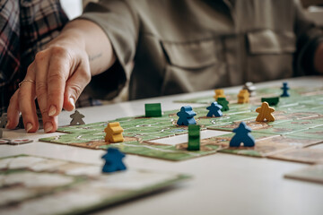 Close-up of women's hand playing board games.Board games concept.Selective focus.