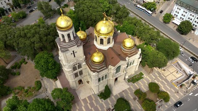 Cathedral in City center of Varna. Urban Landscape. Golden domes of the Assumption Cathedral. Aerial view. Drone flight around the Dormition of the Mother of God. Varna is the sea capital of Bulgaria.
