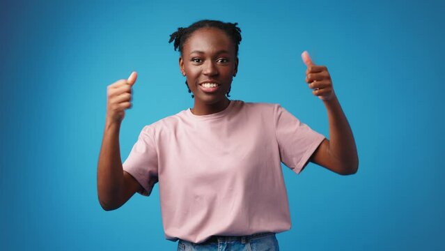 Shocked surprised young african woman against blue background