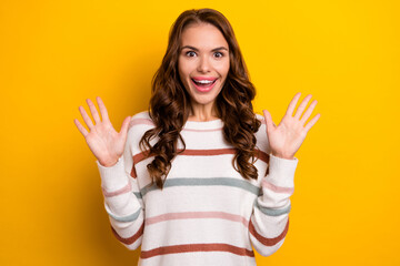 Portrait of nice cheerful lady raise arms palms open mouth cant believe isolated on yellow color...