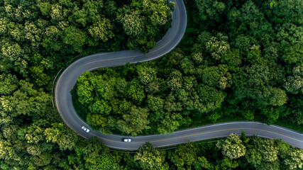 Aerial top view asphalt road in forest with car motion blur, Winding road through the forest, Car...