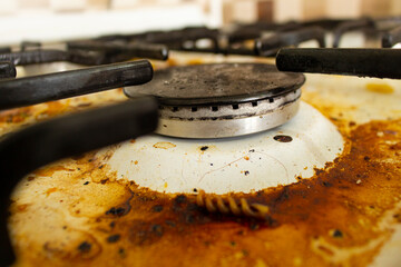 Dirty stove in the kitchen. Dirty gas stove. Unclean hob. Dirty countertop stove. Food residues on...