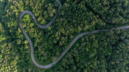 Aerial top view asphalt road in forest with car motion blur, Winding road through the forest, Car...