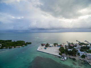 Caye Caulker island in Belize. Cloudy Morning Sky and Caribbean Sea in Background.