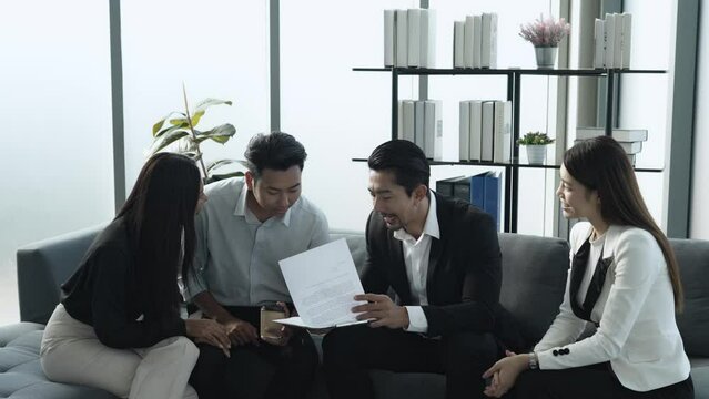 Asian customer with his wife happy sign contract success agreement home buing with real estate property agent realtor and marketing officer 
