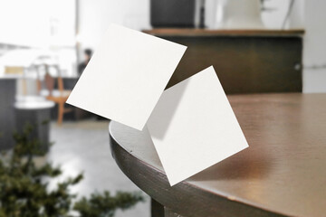 Clean minimal square flyer mockup floating on top table with plant