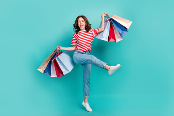 Full length photo of young nice girl wear striped t-shirt denim celebrate spree hold much package sale black friday crazy isolated on cyan color background