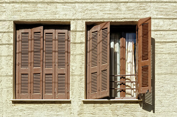 Two windows open and closed with shutters, Chania, Crete, Greece