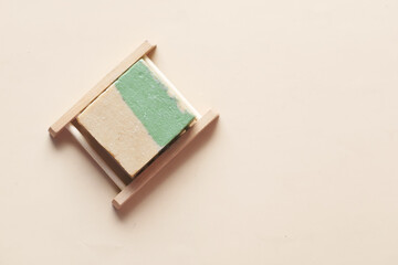 Homemade natural soap bar on yellow background 