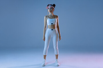 Woman in futuristic sport costume. Augmented reality game, future technology. Neon blue light.