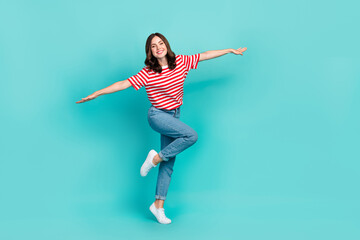 Full length photo of overjoyed lady imagine can fly dream trip abroad wear trendy outfit empty space isolated on cyan color background